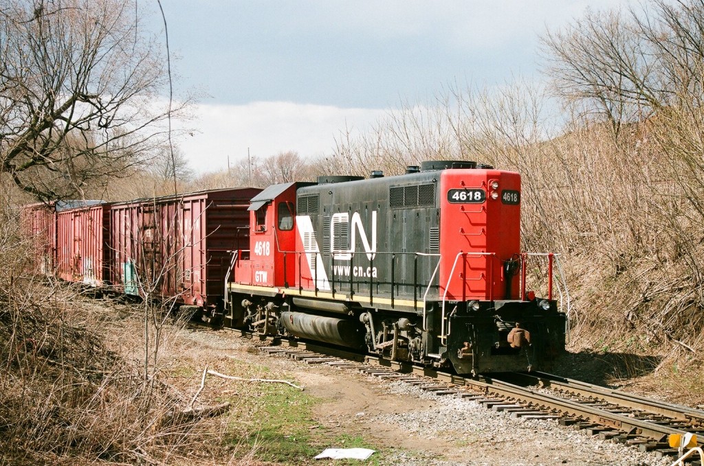 CN GP9R #4618
CN921, with former GTW GP9R #4618, switches boxcars at LC Howard, Kalamazoo, MI.  This facility is jointly switched by NS B-0-K, and CN921.  To line to the right on the embankment is the old PRR mainline, today Norfolk Southern's Upjohn Industrial track. April 10, 2008.
Keywords: Canadian National CN GT CNNA GP9 4618 LC Howard spur Kalamazoo boxcar