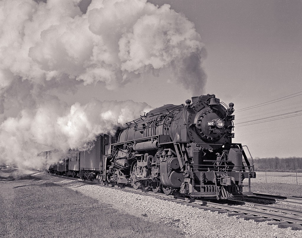 On the Lee Side
DT&I mike 807.  Date and location unknown.
Note the 2 window caboose right behind the
tender.
