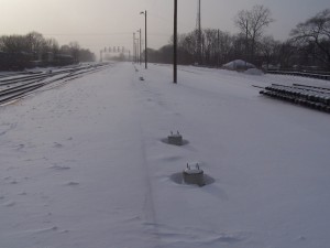 30 small light pole bases planted mostly in pairs with additional small pole bases at the end of the platform and one by the parking lot. I saw one of the large bases and possibly a second but did not dig through the snow to find out.