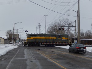 Making the Friedland pickup was their only Lansing work. Before long, their train reassembled and heading back south for home rails. GP9 1758 leads the train south (RR east) at Grand River Ave. on CSX rails past an old cantilever crossing arrangement.