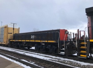 CN yard slug 201-B, class GY00-b, is fourth in the lineup on A492. What is the heritage of this unit and where does it normally reside? 492 met a westbound near E. Durand.