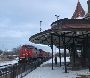A westbound led by CN 2196, mostly autoracks, is about to hit the diamond beside the Durand depot.